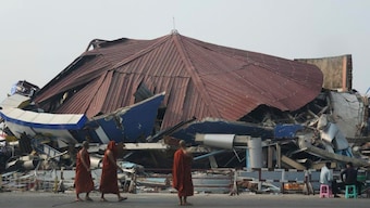 Buddhist monks walk past a collapsed building after a powerful earthquake in Naypyitaw, Myanmar, March 29, 2025. AP