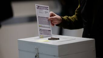 A man places his ballot in a box in Waukesha, Wisconsin. AP/File Photo
