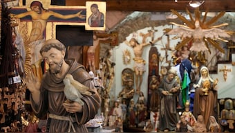 A votive statue of Italy's patron saint, St. Francis, left, is on display at a shop in Assisi, Italy. AP
