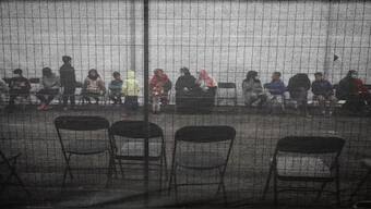Afghan refugees queue outside a distribution and donation center at Liberty Village on Joint Base McGuire-Dix-Lakehurst in New Jersey, U.S., December 2, 2021. Reuters