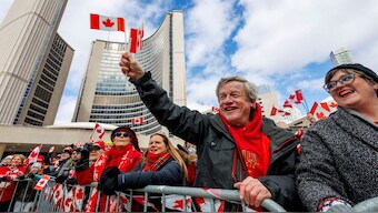 Canadians hold an 'Elbows Up' protest against US tariffs and other policies by US President Donald Trump, at Nathan Phillips Square in Toronto, Ontario, on March 22. The levies and Trump's threat of making Canada the 51st US state are expected to dominate the election. Reuters
