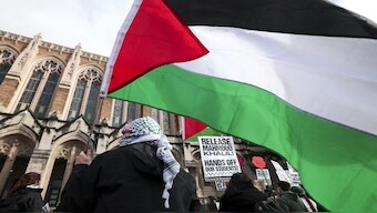 People hold signs and Palestinian flags as they protest the arrest of former Columbia University student activist Mahmoud Khalil and show support for Palestinians. File image/AFP