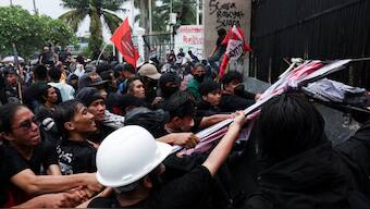 People take part in a protest outside the Indonesian Parliament against revisions to the country's military law, which will allocate more civilian posts for military officers, in Jakarta, Indonesia. Reuters