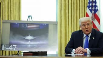 Donald Trump sits next to an image of the F-47 fighter jet. Source: Reuters