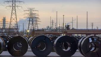 Coils of rolled steel sit in an industrial yard with transmission towers and smokestacks in the background at dusk in Hamilton, Ontario, Canada, January 27, 2025. Source: Reuters