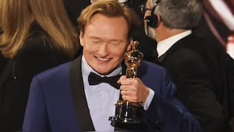 Host Conan O'Brien holds an Oscar statue during the Oscars show at the 97th Academy Awards in Hollywood, Los Angeles. The host steered clear of politics during his monologue at the event, a departure from past awards shows. Reuters
