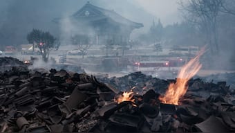 Embers remain among the debris after most of the buildings were burned to the ground in a wildfire at Gounsa Temple in Uiseong on March 26, 2025. AFP