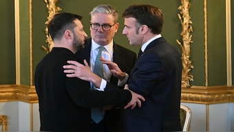 Ukraine's President Volodymyr Zelenskyy, Britain's Prime Minister Keir Starmer and France's President Emmanuel Macron embrace after holding a meeting during a summit at Lancaster House in central London. Reuters