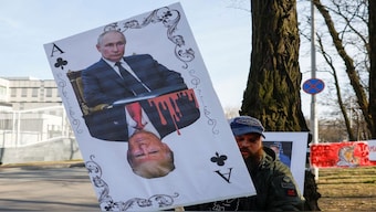 A demonstrator holds a banner depicting a playing card with portraits of Russian President Vladimir Putin and US President Donald Trump during a rally against Trump's stance on the Russia-Ukraine war in front of the US embassy in Kyiv, Ukraine. File image/Reuters