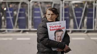 A woman protests, holding a poster of Istanbul Mayor Ekrem Imamoglu, in front of a police cordon blocking the roads leading to the Vatan Security Department, in Istanbul, Turkey. AP