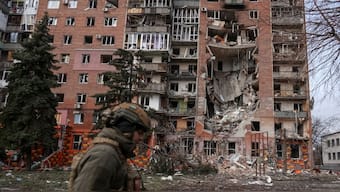 A Ukrainian serviceman passes by a residential building damaged by Russian military strikes in the frontline town of Pokrovsk in Donetsk region, Ukraine. Reuters
