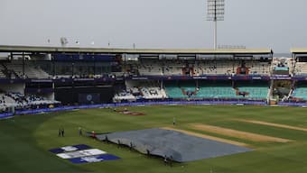 Ground staff taking the covers off the pitch before a match in IPL 2025. Image: Reuters