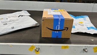 Packages are transported on a conveyor belt at the Amazon warehouse, busy on Prime Day, in Melville, New York, U.S. File image/ Reuters