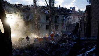 Rescuers at the site of a building hit by a Russian ballistic missile strike in Kyiv on Thursday. Reuters