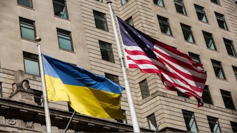 The Ukrainian flag flies alongside an older version of the American flag. 