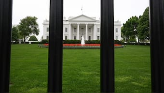 The White House is seen behind bars from a fence in Washington, DC. AFP