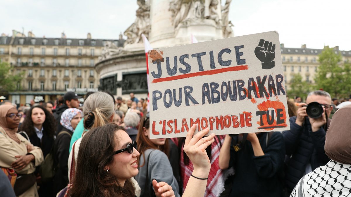 A protestor holds a sign reading "Justice for Aboubakar, Islamophobia kills" during a gathering in tribute to Aboubakar, the worshipper killed in a mosque at La Grand-Combe, and against Islamophobia, at the Place de la Republique in Paris. AFP A protestor holds a sign reading "Justice for Aboubakar, Islamophobia kills" during a gathering in tribute to Aboubakar, the worshipper killed in a mosque at La Grand-Combe, and against Islamophobia, at the Place de la Republique in Paris. AFP