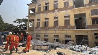 Rescuers work at U Hla Thein Buddhist monastery that collapsed in Friday's earthquake in Mandalay, Myanmar. AP