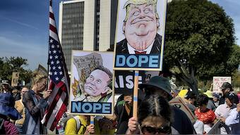Protesters carry signs and chant slogans in protest to the policies of President Donald Trump and Elon Musk across from the Federal Building in the Westwood section of Los Angeles. File image/ AP