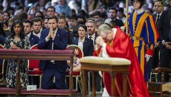 U.S. Vice President JD Vance, and his wife Usha Vance, left, with their daughter Mirabel, attend a Good Friday service led by Cardinal Claudio Gugerotti, right, inside St. Peter's Basilica at the Vatican. AP