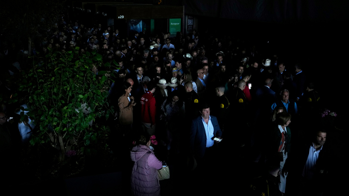 Spectators roam inside the Madrid Open tennis tournament venue during a blackout in Madrid on Monday. AP Spectators roam inside the Madrid Open tennis tournament venue during a blackout in Madrid on Monday. AP