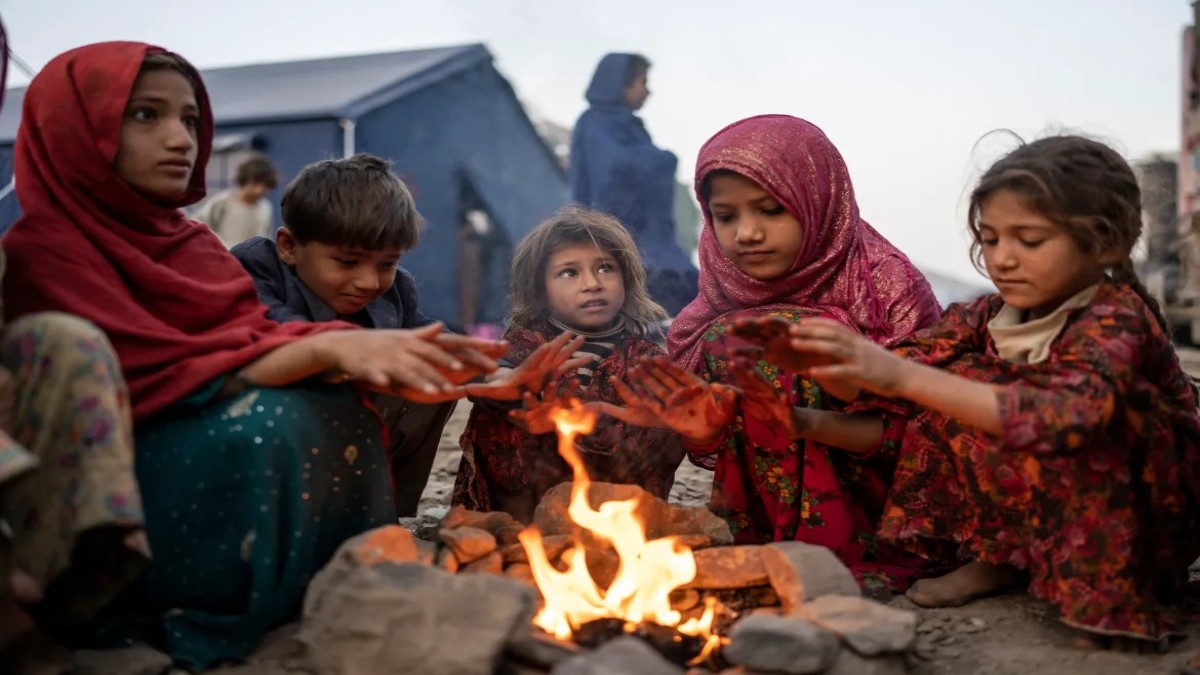 Afghan refugee children huddle around a fire for warmth in a camp on the Afghan side of the Torkham border. Image: Ebrahim Noroozi/ AP Photo Afghan refugee children huddle around a fire for warmth in a camp on the Afghan side of the Torkham border. Image: Ebrahim Noroozi/ AP Photo