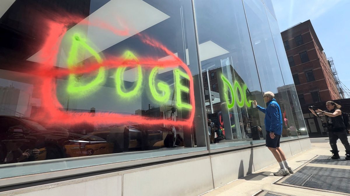 A man sprays paint graffiti against Elon Musk's Department of Government Efficiency (Doge) on a Tesla showroom in New York, US, April 22, 2025, in this still image taken from video. Extinction Rebellion NYC via Reuters A man sprays paint graffiti against Elon Musk's Department of Government Efficiency (Doge) on a Tesla showroom in New York, US, April 22, 2025, in this still image taken from video. Extinction Rebellion NYC via Reuters