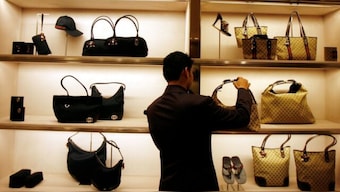 An employee arranges bags at a Gucci showroom in Mumbai, November 25, 2008. (Photo: Reuters) 