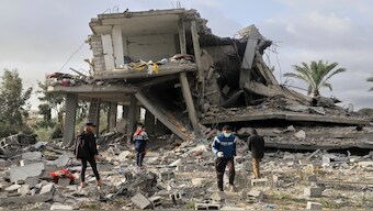Palestinians sift through the rubble of a building hit by an Israeli airstrike that killed at least 17 people, including some from the same family, in Khan Younis, southern Gaza Strip, on Friday. AP 