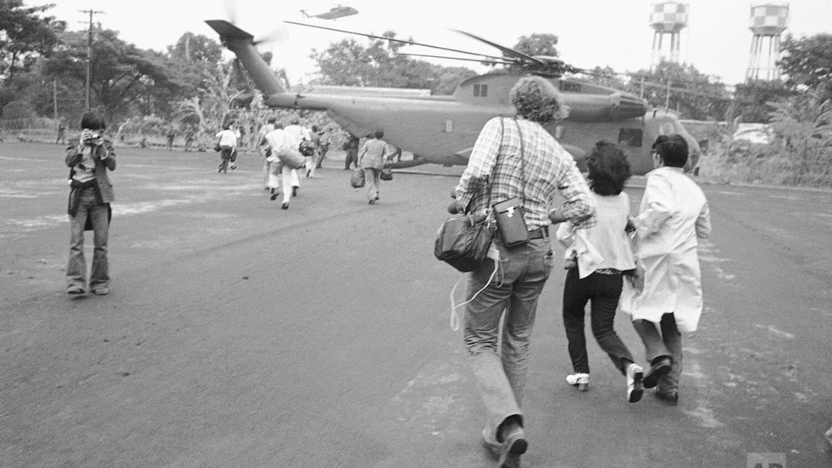 Americans and Vietnamese run for a US Marine helicopter in Saigon during the evacuation of the city, April 29, 1975. File image/AP Americans and Vietnamese run for a US Marine helicopter in Saigon during the evacuation of the city, April 29, 1975. File image/AP