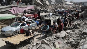 Palestinians make their way with belongings as they flee their homes, after the Israeli army issued evacuation orders, in the Shujaiya neighborhood of Gaza City, on Thursday. Reuters