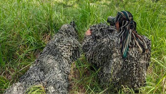 A sniper of Indian Army and his buddy on 'spotter-scope' while on ambush duty on Line of Control (LoC) at a forward location in Nowshera sector of Jammu and Kashmir's Rajouri district. PTI
