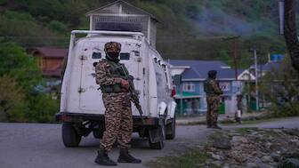 Indian security officers stand guard on a highway in south Kashmir after assailants indiscriminately opened fired at tourists in Pahalgam on Tuesday. AP