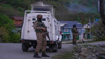 Indian security officers stand guard on a highway in south Kashmir after assailants indiscriminately opened fired at tourists in Pahalgam on Tuesday. AP