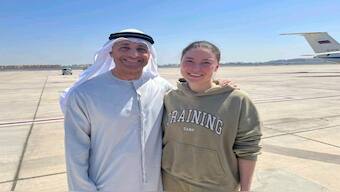 This photo released by the state-run WAM news agency shows Yousef al-Otaiba, the UAE ambassador to the US, left, standing next to US-Russian dual national Ksenia Karelina after her release at an airport in Abu Dhabi, United Arab Emirates, on Thursday. AP