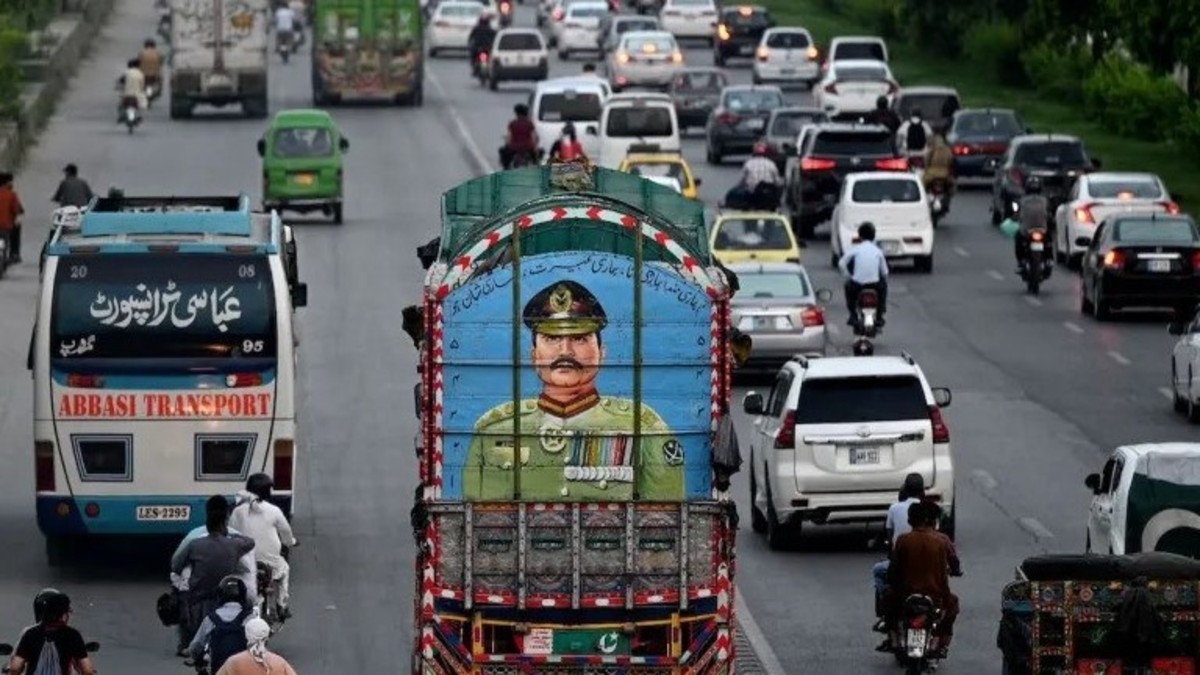 Commuters ride past a truck painted with a portrait of Pakistani Army chief Asim Munir in Islamabad. Representational image: AFP Commuters ride past a truck painted with a portrait of Pakistani Army chief Asim Munir in Islamabad. Representational image: AFP