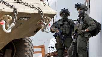 Israeli soldiers stand next to a military vehicle during an Israeli raid in Jenin, in the Israeli-occupied West Bank, on March 4, 2025. Reuters File