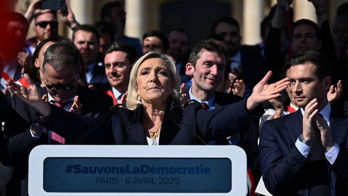 RN party's President Jordan Bardella (R) applauds as President of Rassemblement National parliamentary group Marine Le Pen gestures after delivering a speech during a rally in her support, after she was convicted of a fake jobs scheme at the EU parliament, in Paris on April 6, 2025. Image- AFP RN party's President Jordan Bardella (R) applauds as President of Rassemblement National parliamentary group Marine Le Pen gestures after delivering a speech during a rally in her support, after she was convicted of a fake jobs scheme at the EU parliament, in Paris on April 6, 2025. Image- AFP