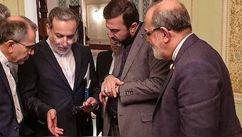 This handout picture provided by Khabar Online on April 12, 2025, shows Iran's Foreign Minister Abbas Araghchi (2nd-L) speaking with members of the Iranian delegation after a meeting in Muscat. Image- AFP