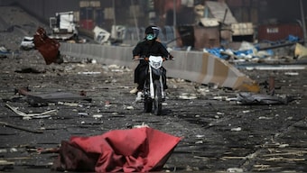 Men ride a motorcycle amid the devastation on a boulevard following an explosion at the Shahid Rajaee port dock southwest of Bandar Abbas in the Iranian province of Hormozgan on April 26, 2025. Image- AP