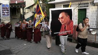 Tibetan refugees carry a portrait of Trulku Hungkar Dorjee, a revered Tibetan religious leader, who first died in Vietnam, in Dharamshala, India, Friday, April 11, 2025. Image: Ashwini Bhatia - AP