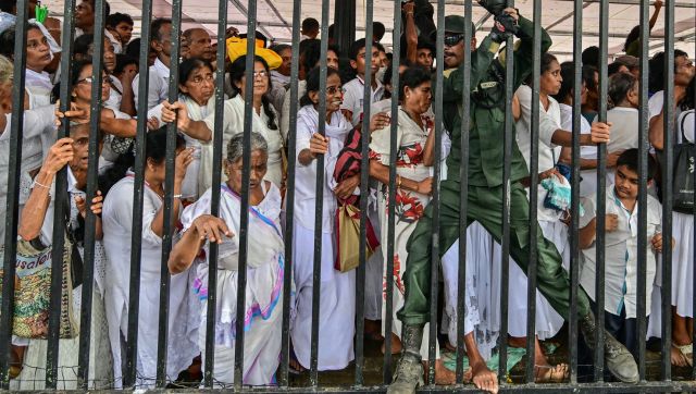 A military official (R) tries to help devotees avoid chaos during a gathering for a public exposition of the sacred. AFP