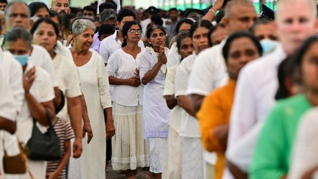 Buddhist devotees stand in queues as they wait to enter the Temple of the Tooth for a public exposition of the sacred Tooth relic of the Buddha in Kandy. AFP