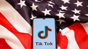 Tik Tok logo is displayed on the smartphone while standing on the US flag in this illustration picture taken on November 8, 2019. Reuters File 
