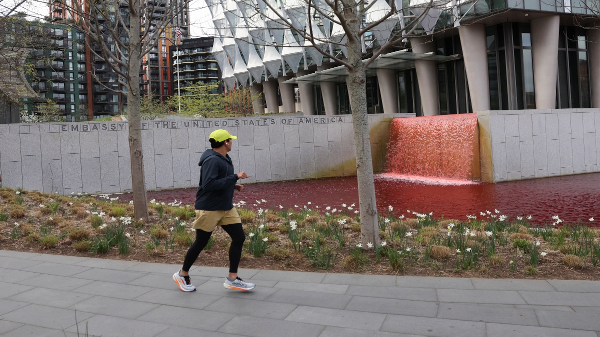 A man runs next to the US Embassy pond filled with red dye by Greenpeace activists, in protest against arms sales to Israel, in London, Britain, on Thursday. Reuters A man runs next to the US Embassy pond filled with red dye by Greenpeace activists, in protest against arms sales to Israel, in London, Britain, on Thursday. Reuters