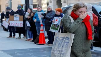 A recently fired US Agency for International Development (USAID) staff member reacts while leaving work, during a sendoff by former USAID staffers and supporters outside USAID offices in Washington, DC, US, on February 21, 2025. Reuters File