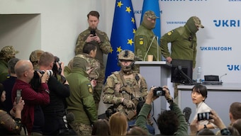Ukrainian security officers escort a Chinese national, center-left, back to camera, who was captured by Ukrainian forces while fighting on the Russian side, to a press conference in Kyiv, Ukraine, April 14, 2025. File Image/AP