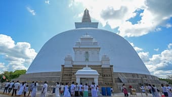 Buddhist devotees offer prayers during Poya, a religious festival to mark the full moon at the Ruwanwelisaya Temple in Anuradhapura on April 5, 2023. File Photo/AFP