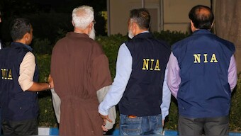  Mumbai terror attack accused Tahawwur Hussain Rana with NIA officials upon his arrival at the IGI Airport, in New Delhi, on April 10, 2025. NIA via PTI Photo