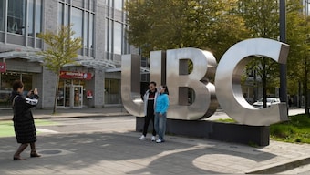 Family members take photographs at the entrance of the University of British Columbia (UBC) in Vancouver, British Columbia, Canada April 14, 2025. REUTERS 